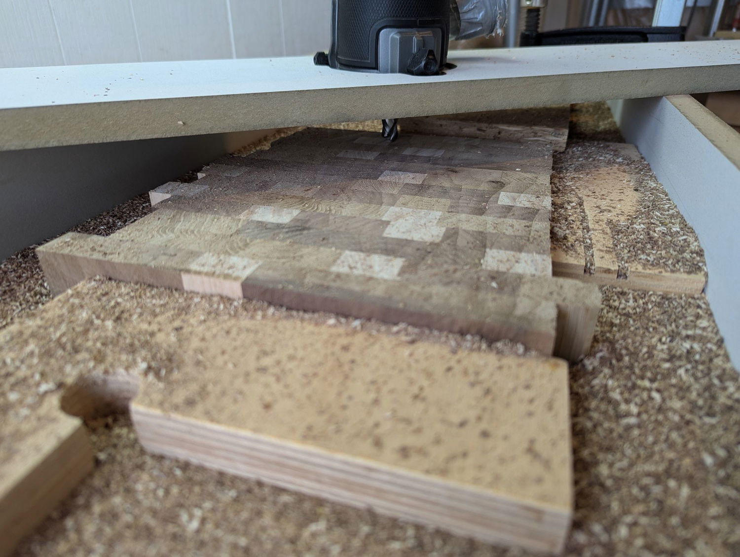 Using router sled to flatten one side of the board first. I used some shims to avoid the piece from rocking while I was flattening it.