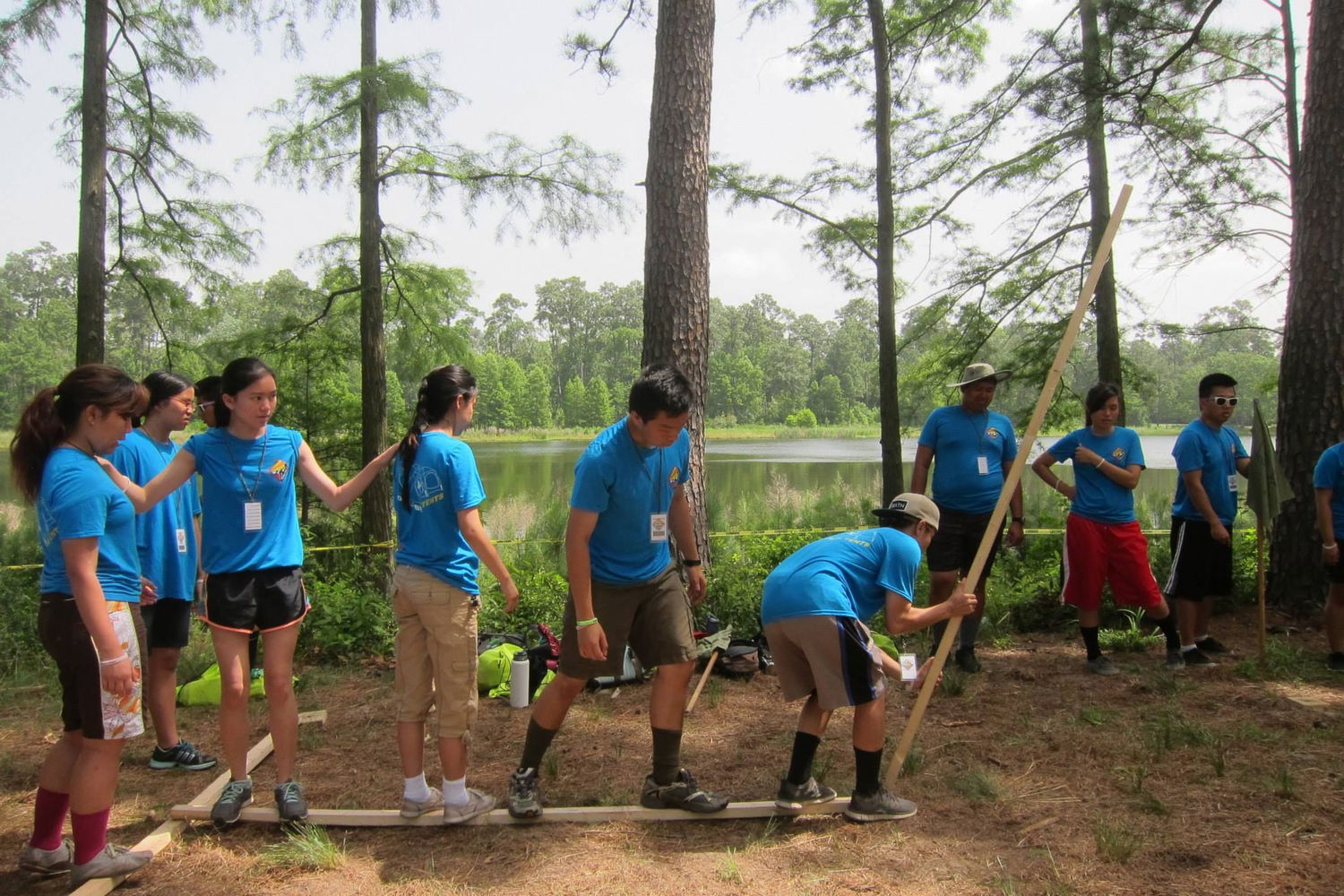 Venture Scouts practice communication and teamwork in a low cope activity during the International Vietnamese Scouting Jamboree in Houston, Texas.